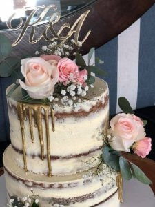 two tier wedding cake with extra tall tiers in a rustic style