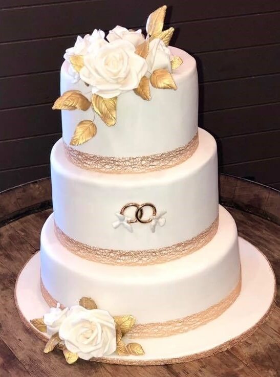 3 tier white wedding cake gold leaf and sugar flowers