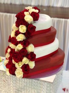 4 tier heart shaped red and white wedding cake