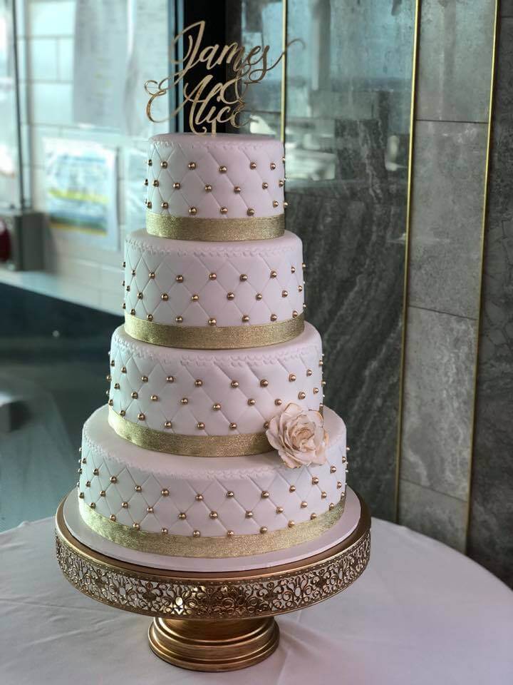 4 tier wedding cake with gold pearls and quilted fondant finish
