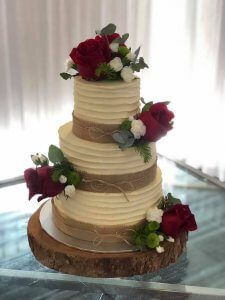 3 tier butter cream wedding cake with fresh roses