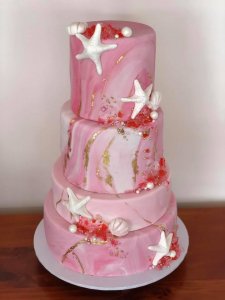 pink beached themed wedding cake