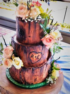 3 tier log themed wedding cake with fresh flowers and custom cake topper by rimma's wedding cakes perth