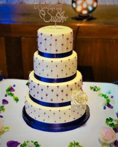 4 tier white wedding cake with purple ribbon and edible diamonds by rimma's wedding cakes perth